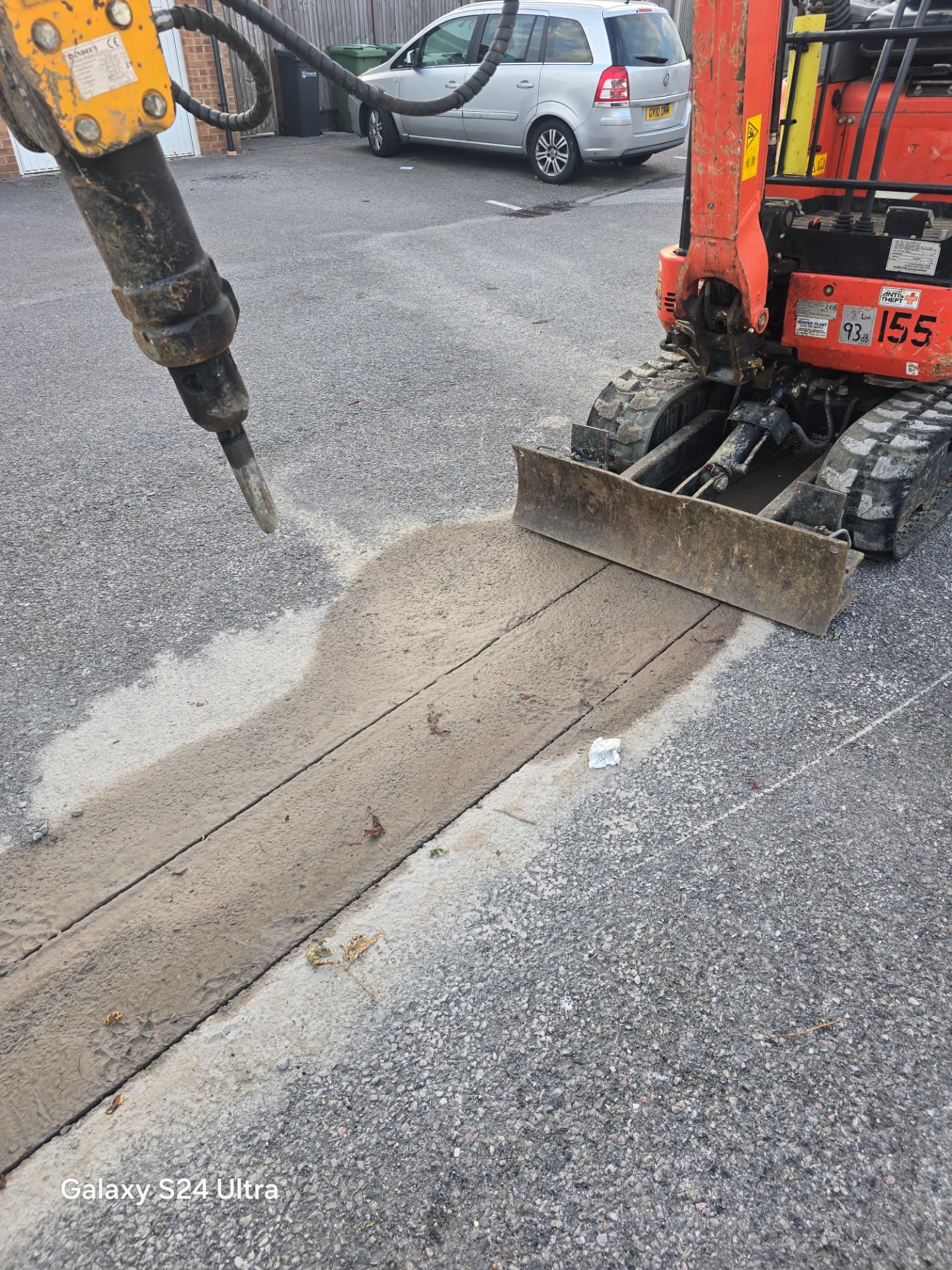 Hydraulic breaker on an excavator starting to break out the Portsmouth hardstanding