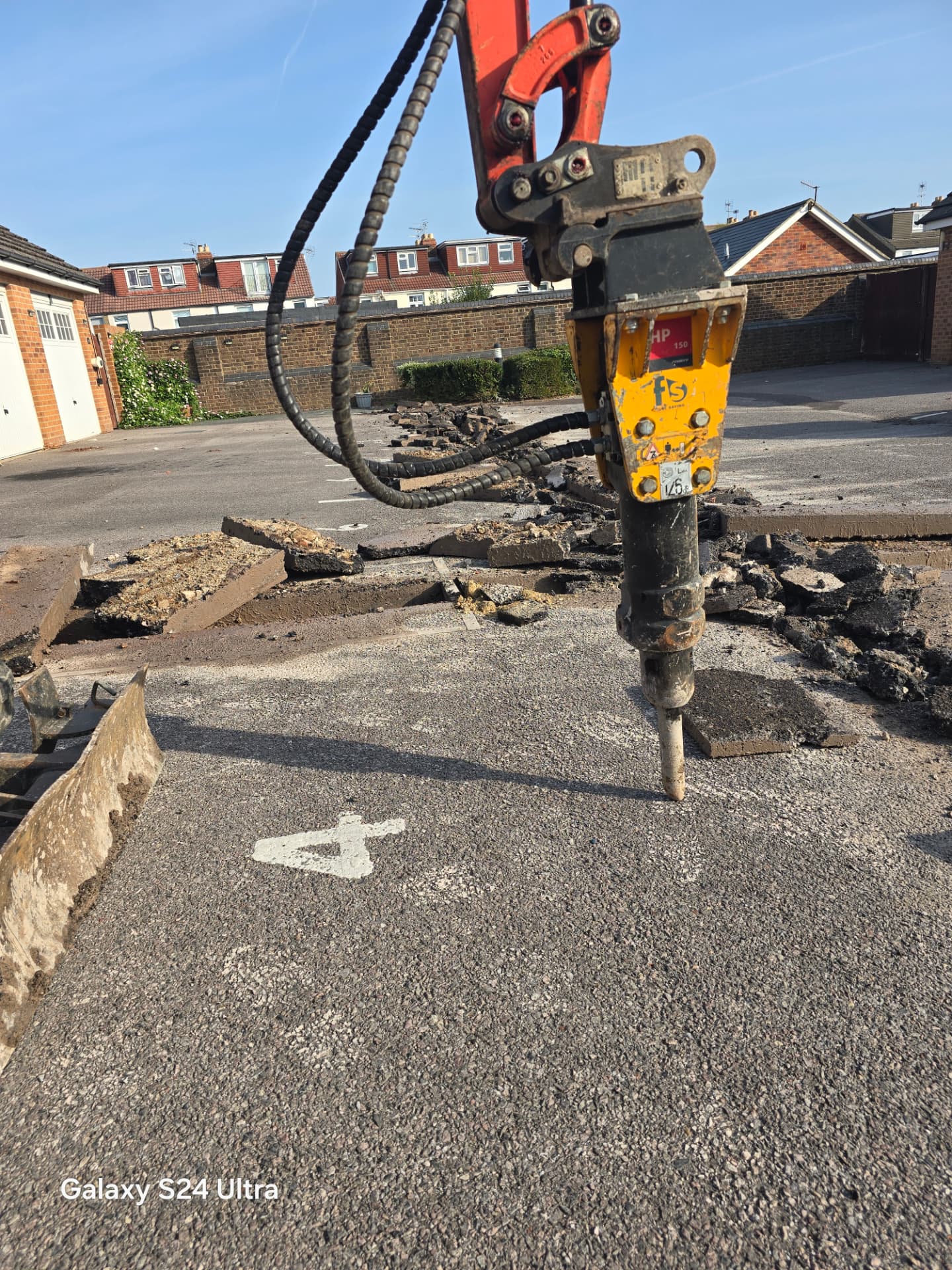 Excavator-mounted hydraulic breaker breaking out the cable route in Portsmouth